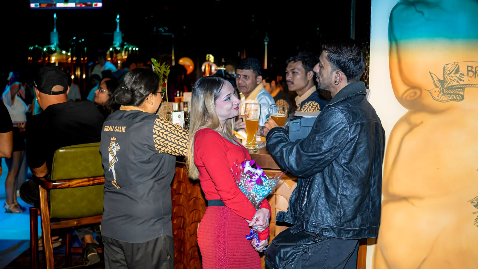 Outside the venue at night, the bar glowing